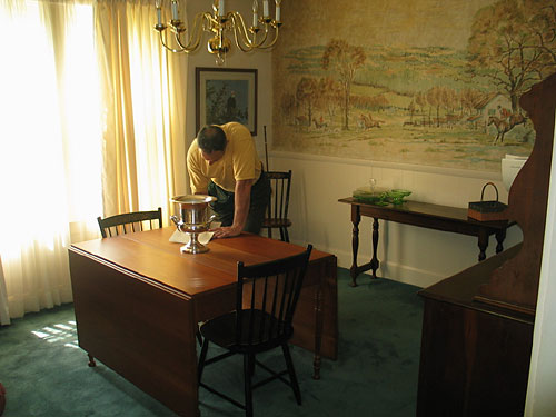 With John, our helpful home inspector. The walls are yellow from cigarette smoke, and that's a huge wallpaper mural of a fox hunt behind him. You're facing the northwest front corner of the house.