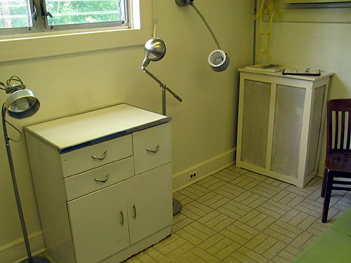 You're facing the back southeast corner of the house. To the immediate right is the gynecological exam table. (yuck.)